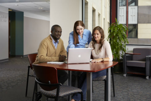 Associate Professor of Management and Human Resources Maria Triana working with students