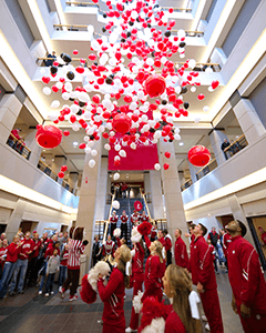 Students and alumni celebrate the Wisconsin Naming Gift announcement during a Homecoming celebration at Grainger Hall