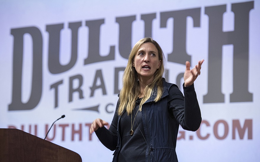 CEO Stephanie Pugliese speaks against a backdrop of the Duluth Trading Company logo