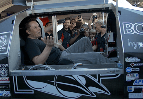 Elon Musk sits in the Badgerloop pod