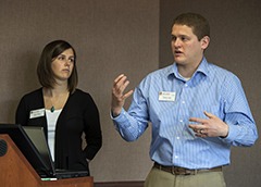 Stephen Larsen, MBA student S.C.M., talks about the "Farm to Table" concept during his presentation on Friday, May 13, 2016 at Grainger Hall as co-presenter Mallaory Ballard looks on.