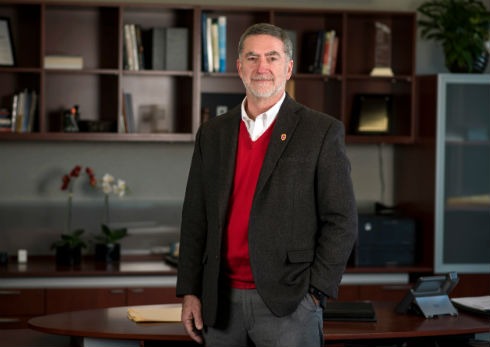 Barry Gerhart stands in his office