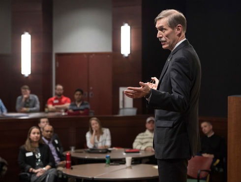 Karl F. Schneider speaks onstage during an evening Weikel talk