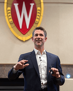 A photo of Kevin Conroy speaking to Wisconsin MBA students