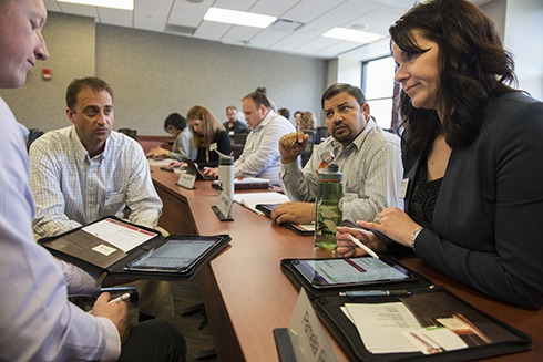 Wisconsin Executive MBA students (R-L) Pamela Petz, Amit Sharma, Scott Carlsen, and Justin Fagan use their new iPad Pro tablets to go over course work in their managerial economics class during the first week of the Fall 2016 semester.