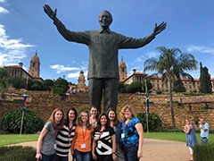 Wisconsin MBA students stand next to a Mandela statue in Pretoria