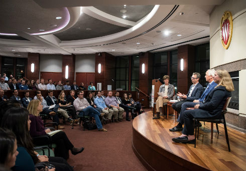 MBA students listen to alumni Weikel speakers in the Plenary Room