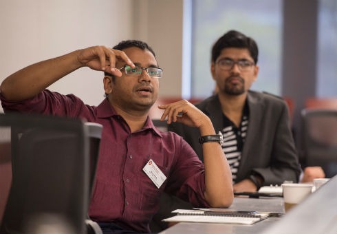 A student asks a question during the seminar