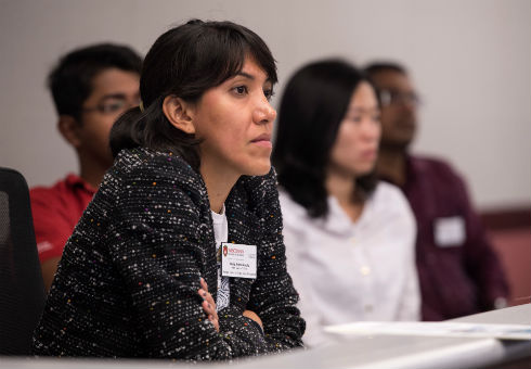 A student listens intently to a speaker