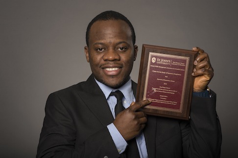 Adolph Okine holding Best Paper Award