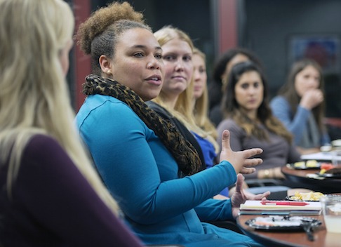 Ashleigh Coaxum speaks as people around her listen.