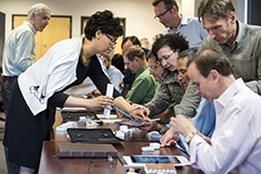 Leslie Petty (left), assistant dean of the Executive and Evening MBA Program at the Wisconsin School of Business, helps Wisconsin Executive MBA Program faculty set up their iPad Pro tablets during a summer training session.