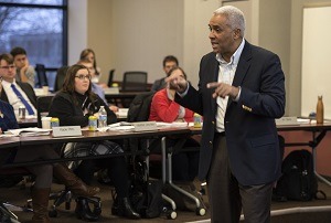 Roger Ervin lectures in front of audience