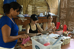 An image of three women packing soap in Ecuador