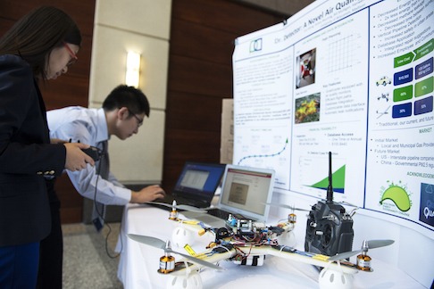 Cheng Liu and Eva Wang set up booth at Burrill Business Plan Competition