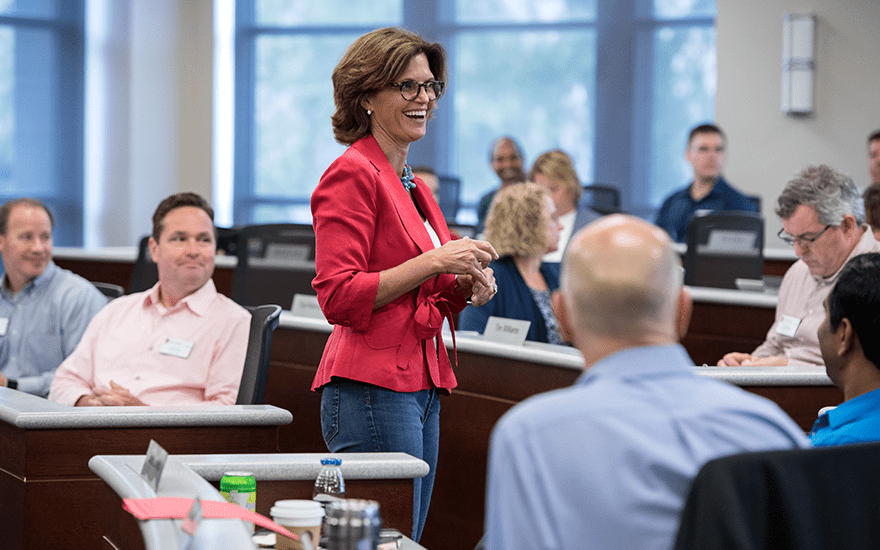 Faculty Associate Deb Houden teaches Executive MBA students in a Grainger Hall classroom.
