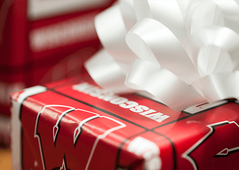 Present wrapped in University of Wisconsin wrapping paper
