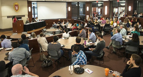 A crowd of faculty and students listens as the members on the panel discuss the Cultivating Inclusion