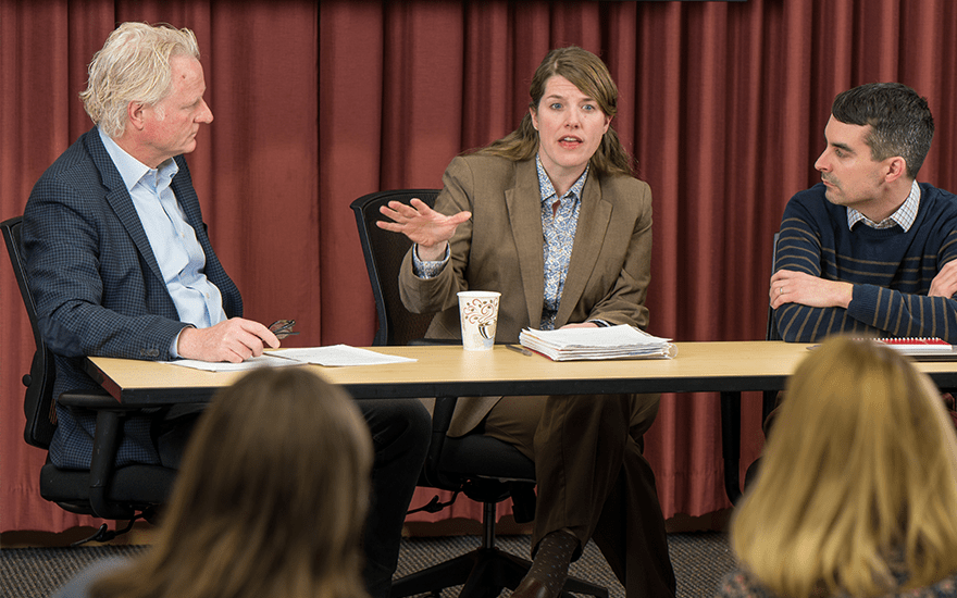 Director Kristin Branch gestures while speaking on a panel