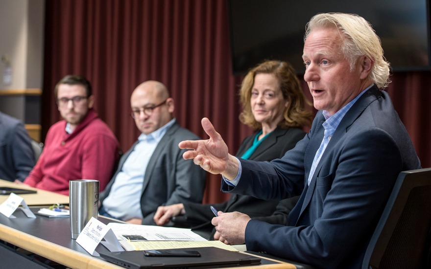 Mark Eppli (right) discusses current topics on a recent faculty panel.