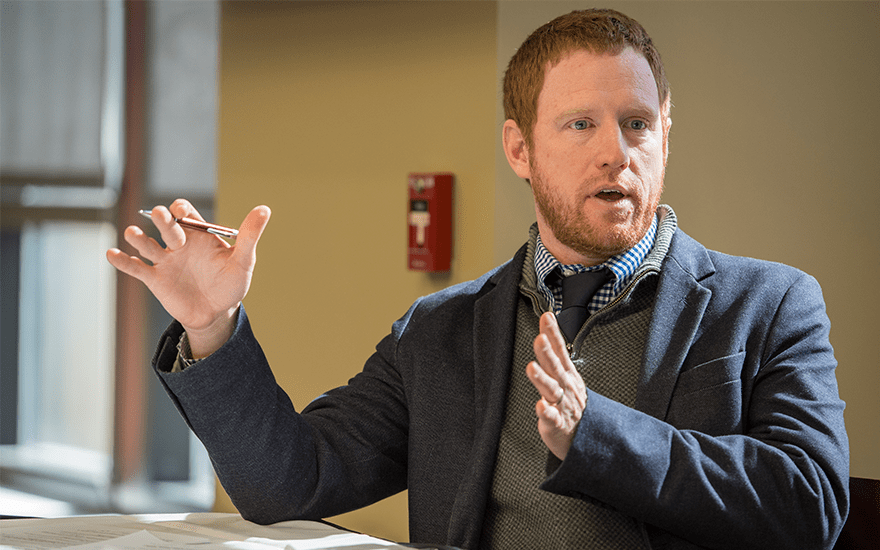 Reporter Jonathan O'Connell gestures as he speaks on a faculty panel