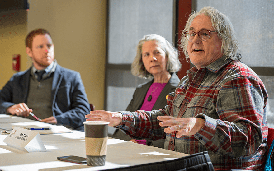 Thomas O'Guinn gestures as he speaks on a faculty panel