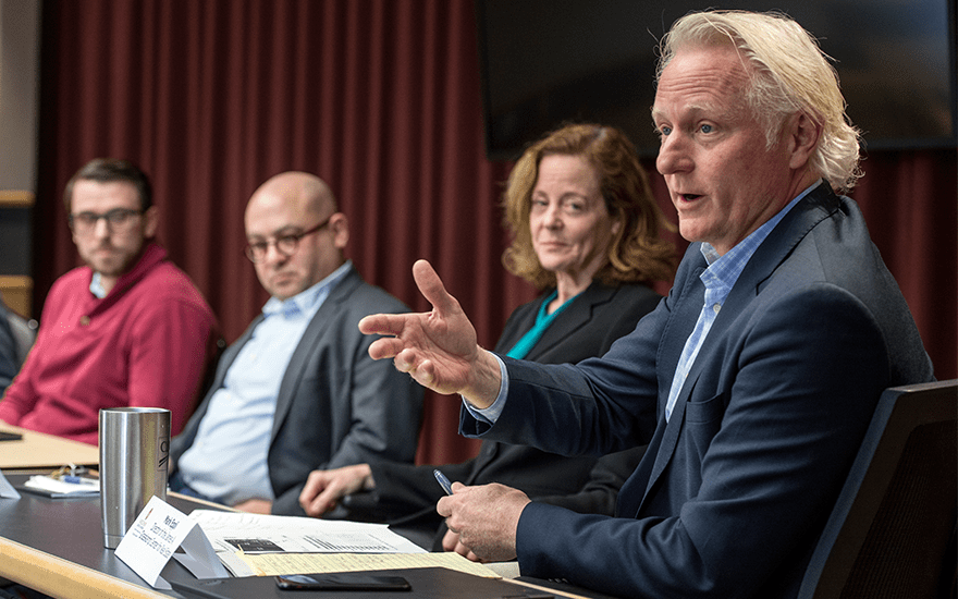 Mark Eppli gestures while making a point during a faculty panel