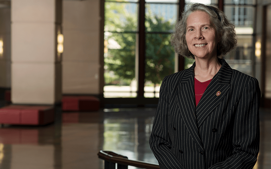 Professor Joan Schmit stands for a portrait in Grainger Hall