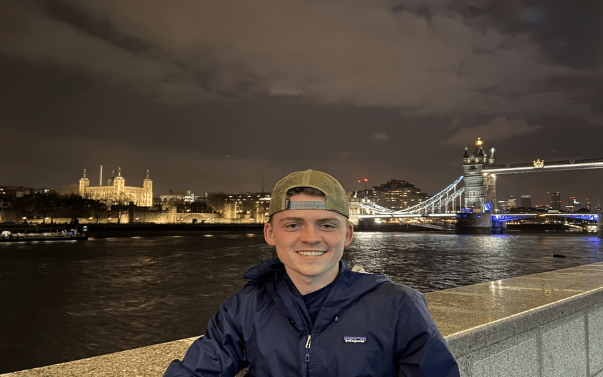 Student standing near River Thames in London, England