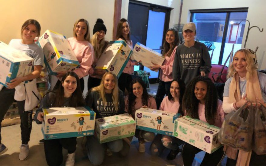 Women in Business members donating diapers