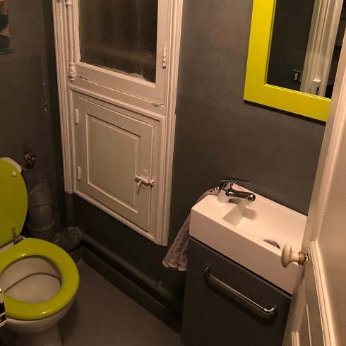 Green toilet seat in a green bathroom