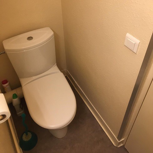 Modern toilet with flushing mechanism on top of the toilet tank