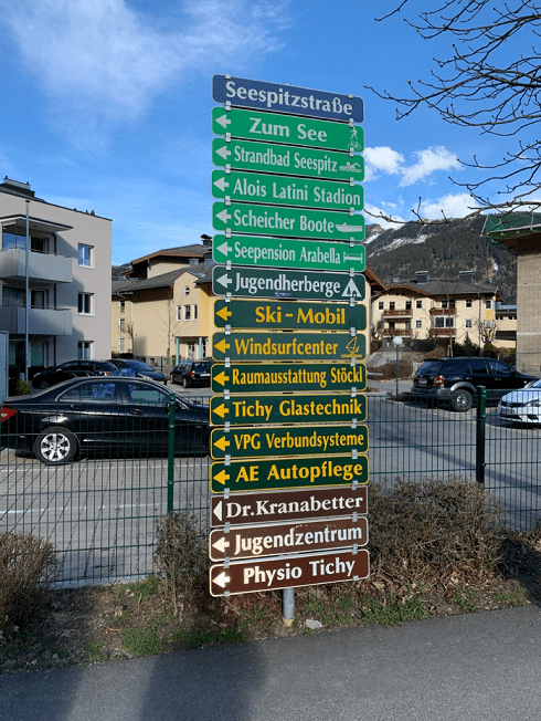 cool street sign with lots of arrows