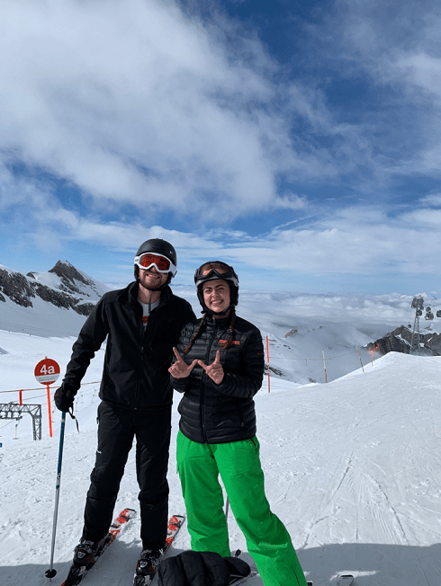 Clouds that blend into the mountains and friends at the top of a ski hill