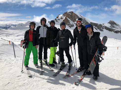 group of friends at the top of the ski hill