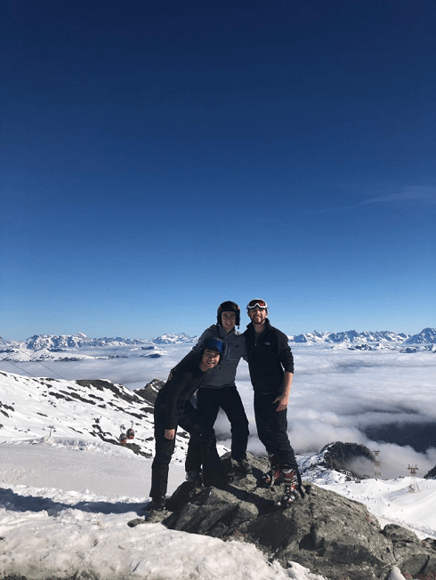 friends at the top of a ski hill