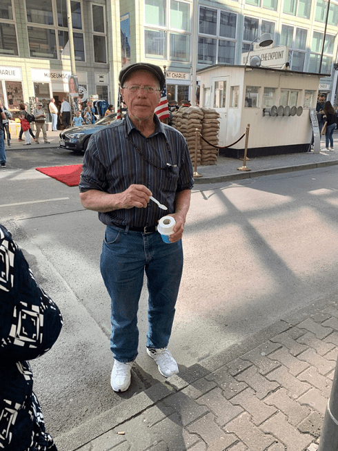 my grandfather eating a treat at Checkpoint Charlie