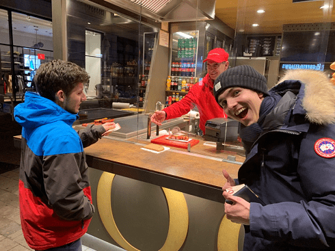 My friends and I buying sausages on the street