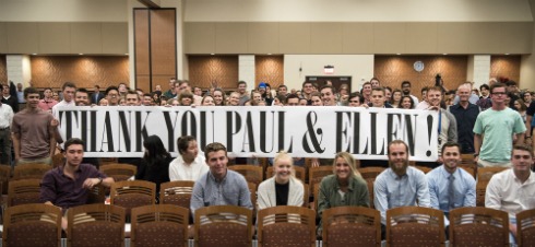 Students holding up a sign thanking Paul Reckwerdt and Ellen Rosner