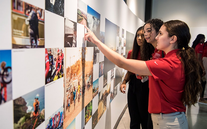Students looking at photos on a wall