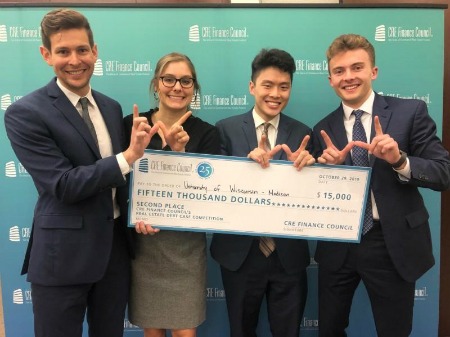 CREFC team holding a giant check