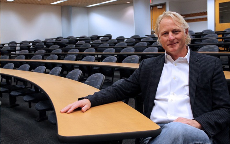 Mark Eppli sitting in empty classroom