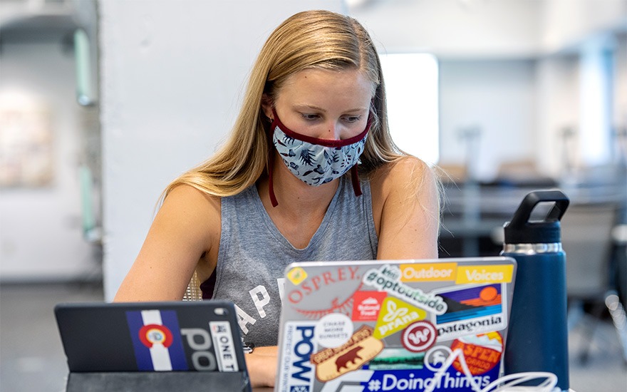 A business student uses her laptop