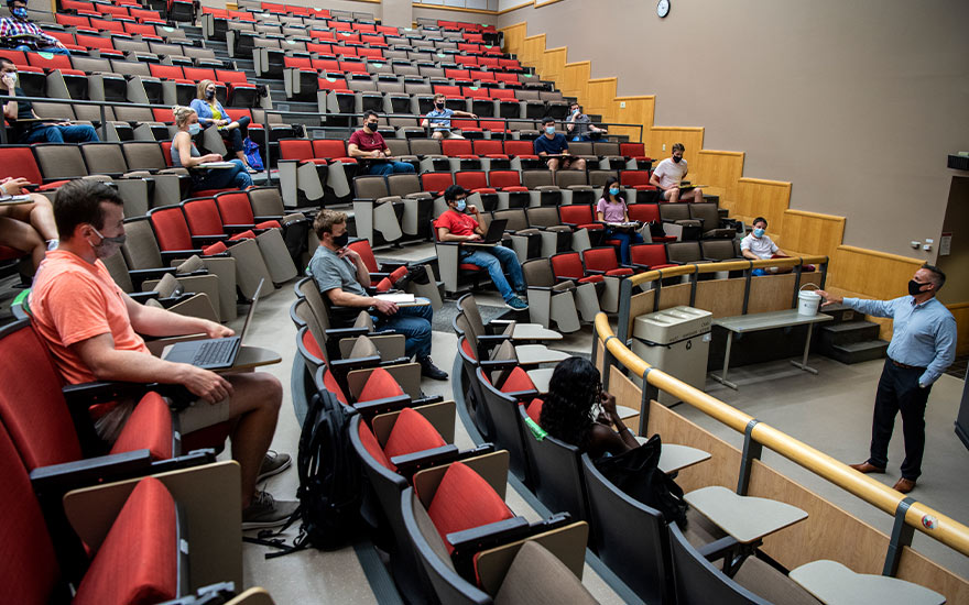 Students seating in an auditorium during a lesson