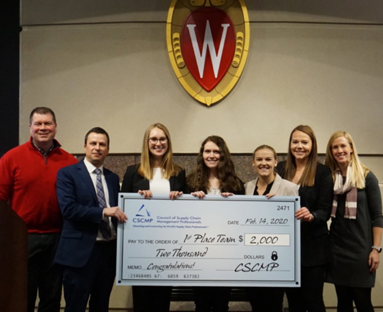 Winners holding giant check