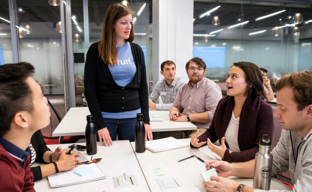 Students networking with an Intuit representative