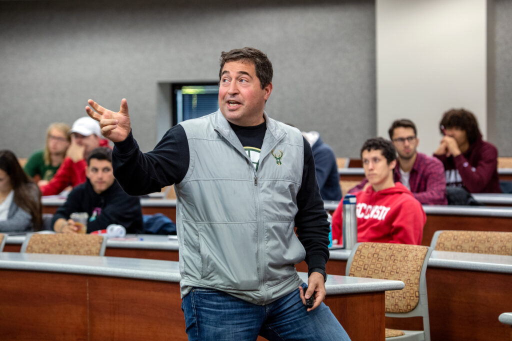 Peter Feigin, Milwaukee Bucks President, speaking to a class at Grainger Hall