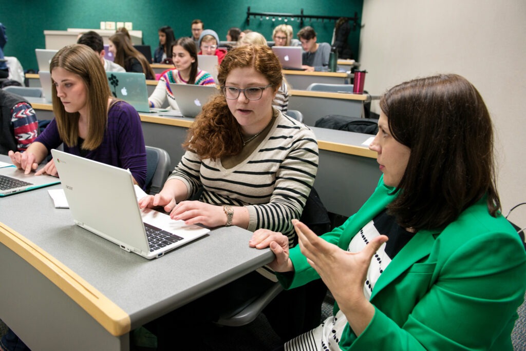 Professor Katie Krueger helping students