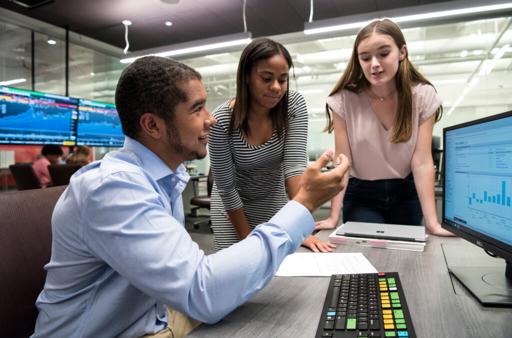 Three students working together at a computer