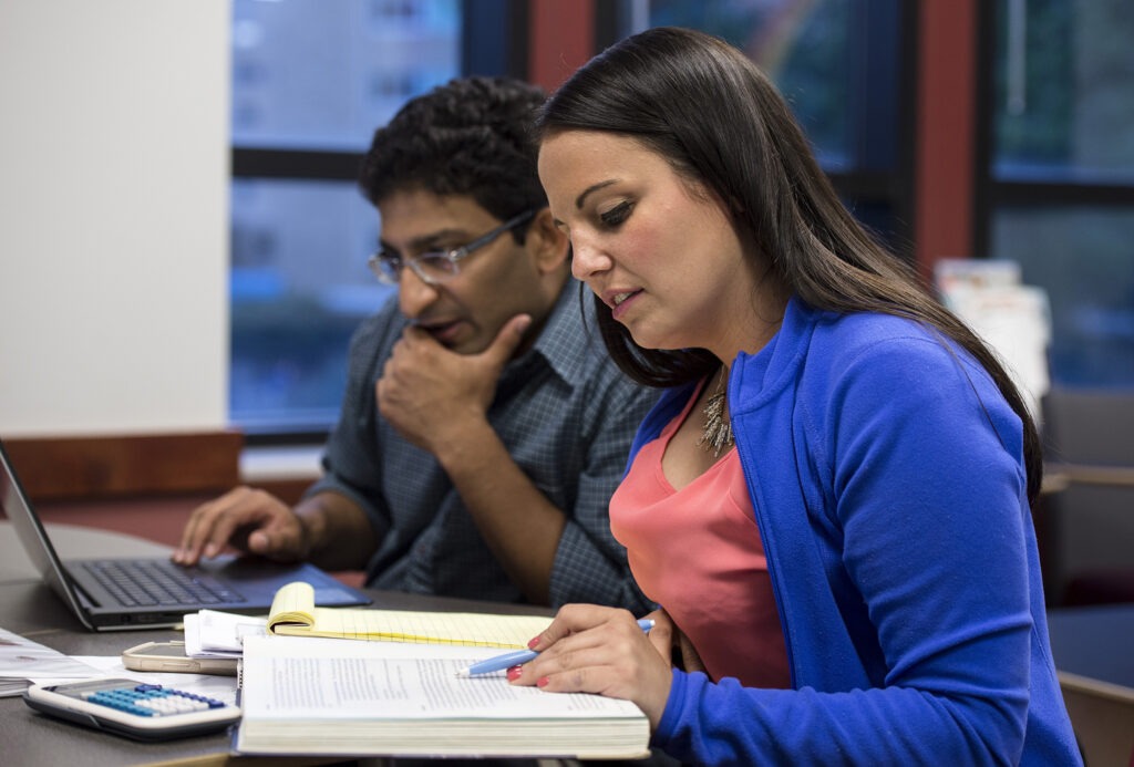 students working on books